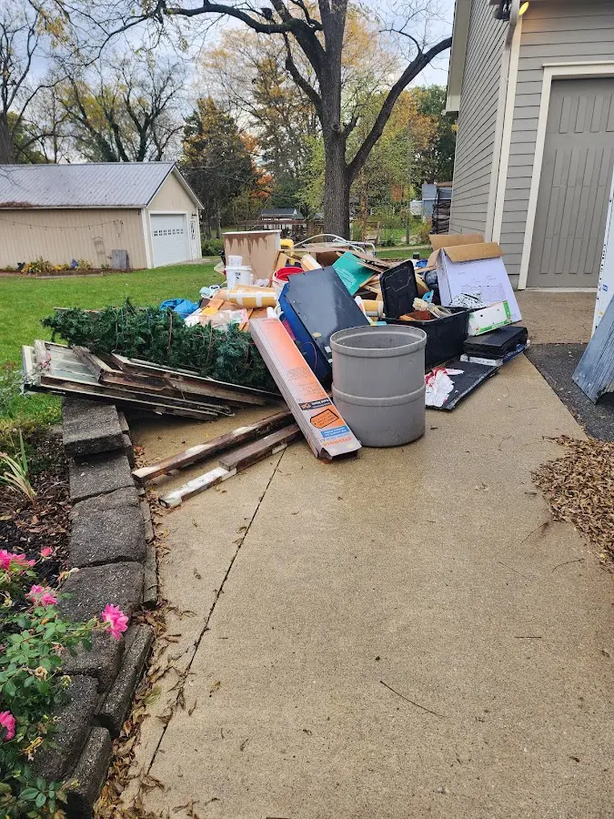 Dumpster being loaded with debris for Estate Cleanout Dumpster Rental in Gustine